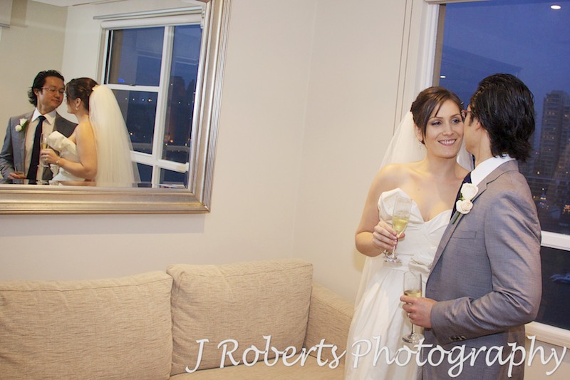 Bride and groom looking at each other with reflection in the mirror - wedding photography sydney